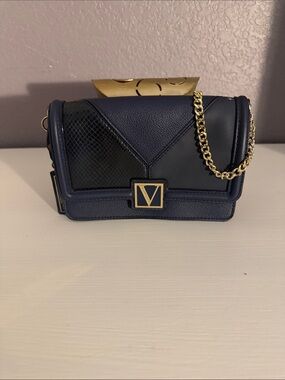 Victoria’s Secret crossbody bag with gold chain.